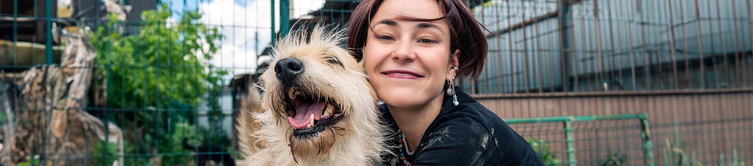 Woman and dog hugging