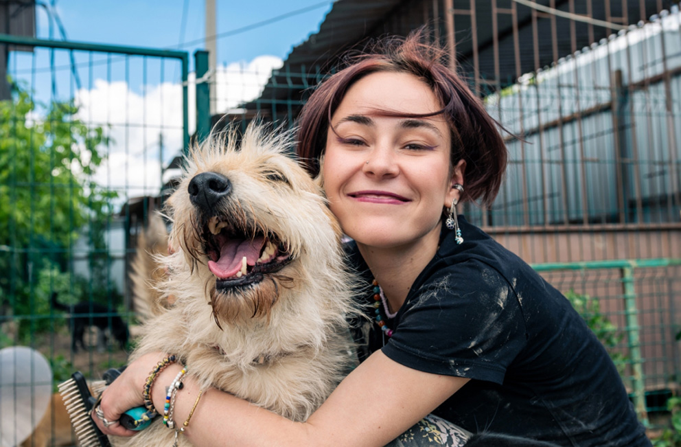 Woman and dog hugging